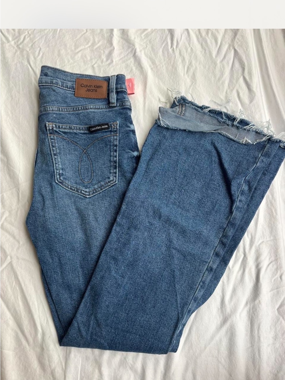 Calvin Klein Medium Wash Flare Leg Jeans with Raw Hem